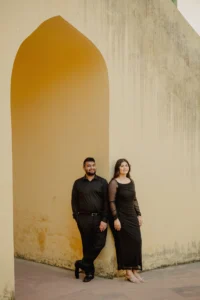 Couple standing under an arch at Jantar Mantar, Jaipur