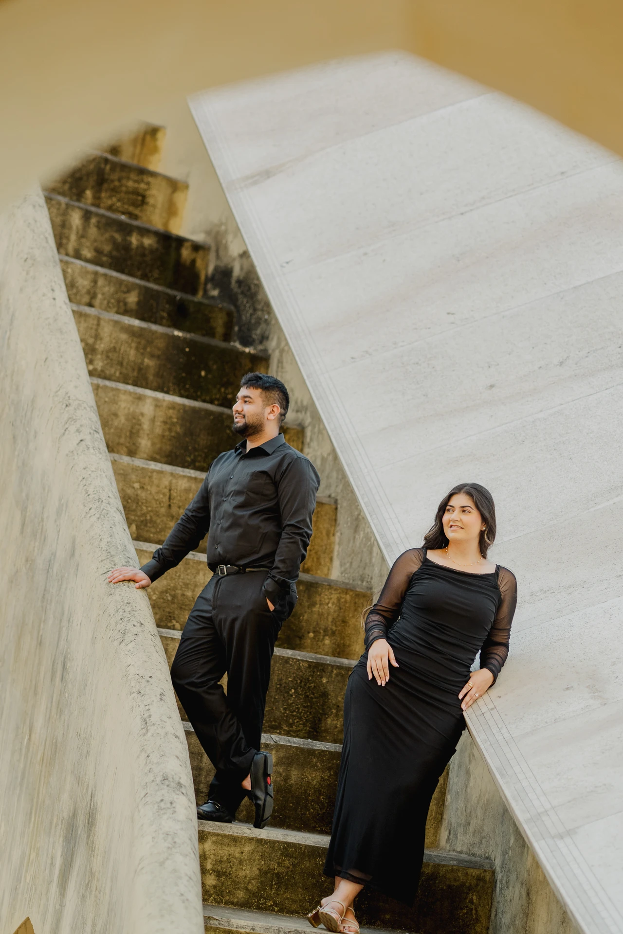 Couple walking down a narrow stone staircase