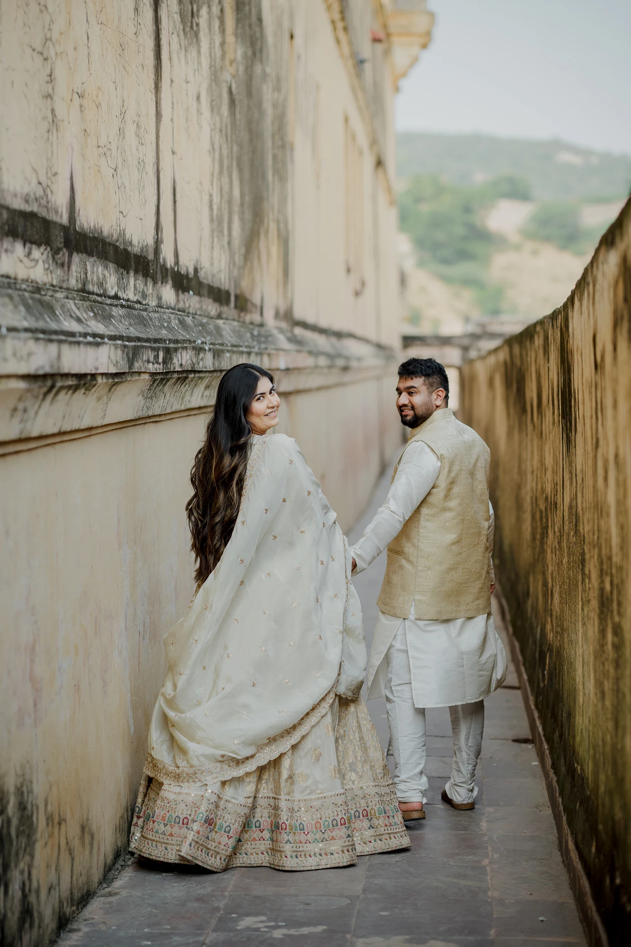 Couple walking down a stone staircase, Amer Fort
