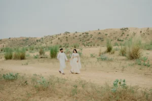 Couple walking together in sand dunes, Jaipur pre-wedding shoot