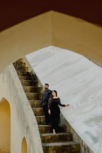 Couple walking up a stone staircase, black attire