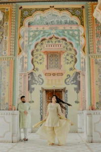 Woman standing alone under a painted gateway, Jaipur