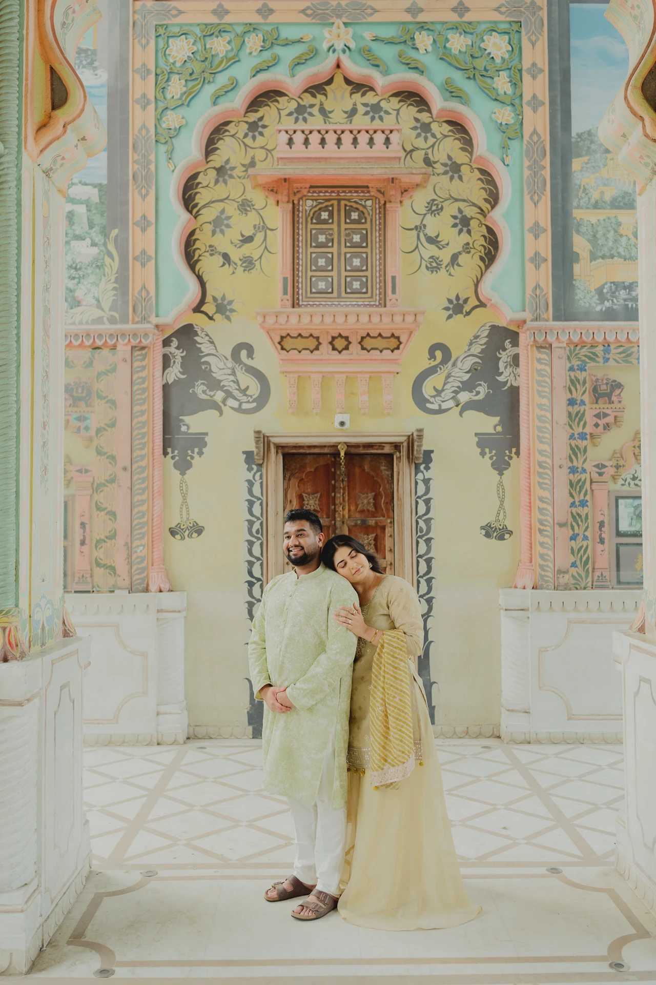 Woman standing solo at a mosaic archway, Jaipur pre-wedding shoot